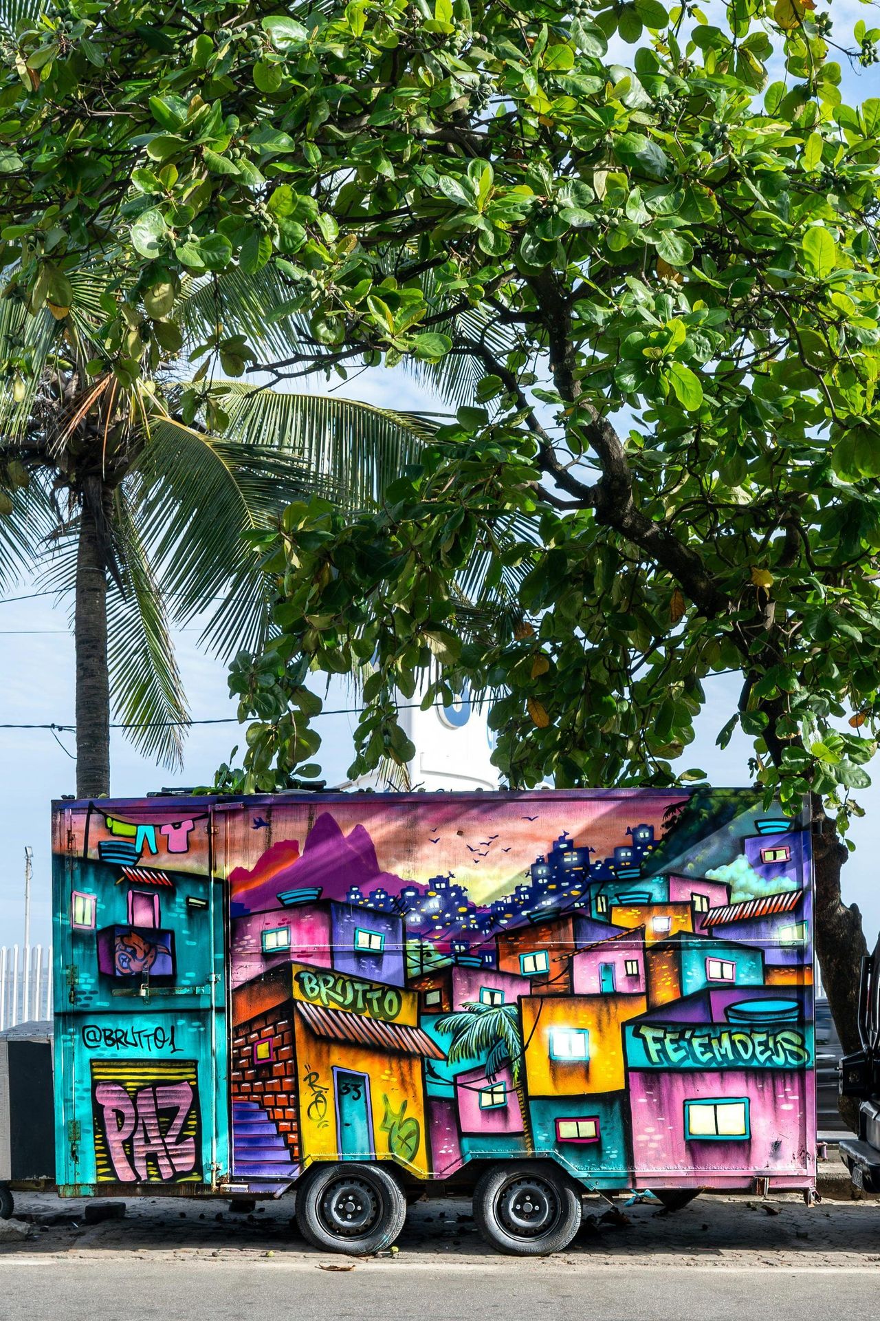 A view over the rooftops of Vidigal toward Leblon and the Atlantic, showing the neighborhood's layered hillside houses